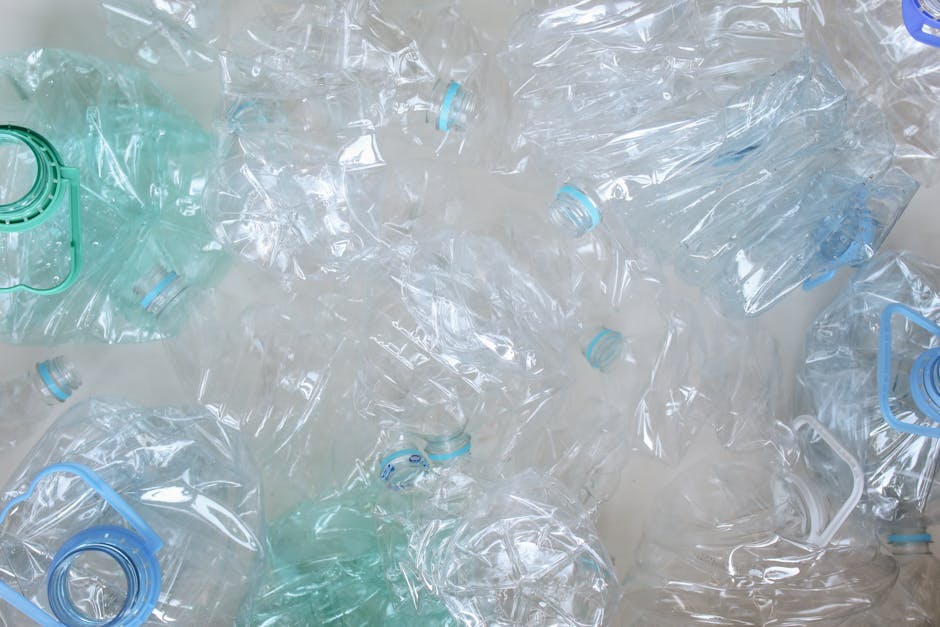 An overhead shot of crushed plastic bottles ready for recycling, promoting eco-friendly practices.